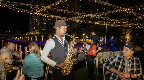 Dubai Creek night cruise with riverside views, buffet dinner, Tanoura show, optional transfers/upper deck seating Transport Passes in Dubai